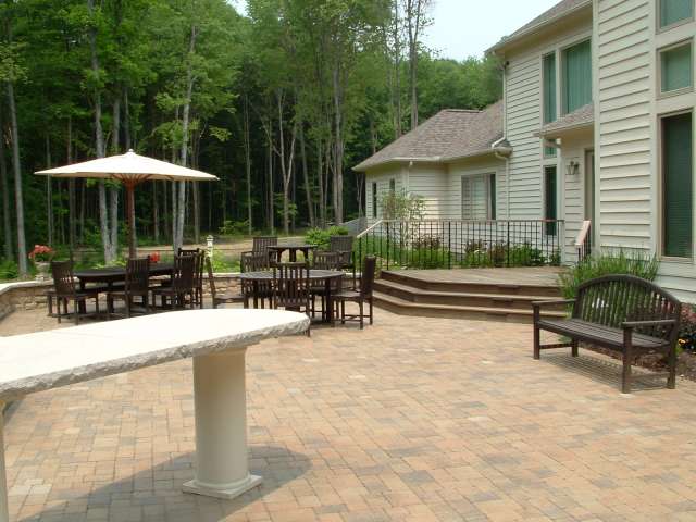 Close up of rear patio showing deck and outdoor kitchen serving bar. Landscape designer located near Geauga County Ohio.
